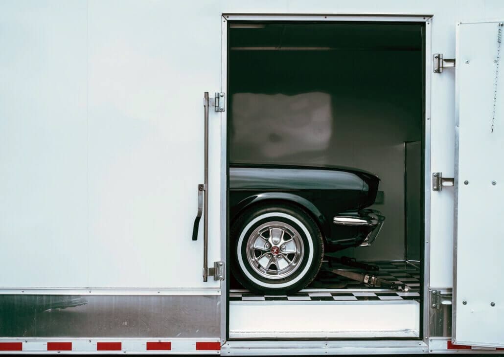 Vehicle in an enclosed trailer with door open